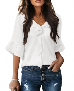 Detail of white V-neck top showing ruffled texture fabric and lantern sleeve ruffles