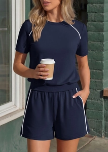 Detail of navy blue knit lounge set featuring white contrast piping and drawstring shorts
