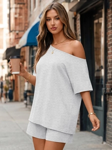 Detail of light gray two-piece lounge set with off-shoulder top and matching shorts