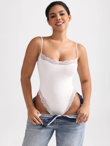 Detailed close-up of white bodysuit with delicate lace trim and Italian spaghetti straps