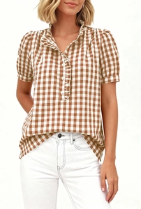 Detailed view of women's short sleeve gingham shirt with ruffled collar and brown checkered pattern