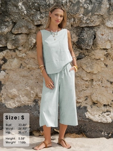 Close-up of women's sleeveless cotton striped top with chest pocket and drawstring pants