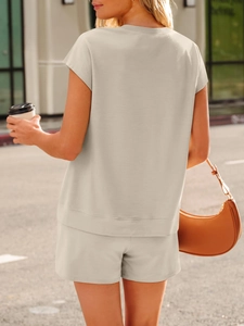 Detail shot of the beige knit cotton summer set fabric and loose fit from a back view