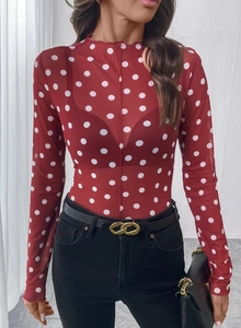 Dettaglio del top in rete rossa a pois bianchi con eleganti bordi a onde sul collo