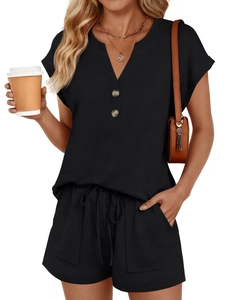 Detail of black summer two-piece set featuring V-neck buttons and drawstring shorts