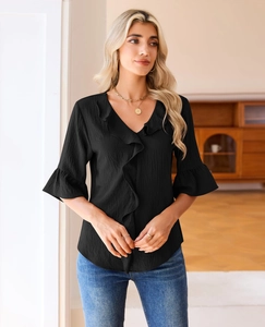 Detail of elegant V-neckline with layered ruffles on a black pleated chiffon blouse