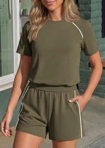 Detail of olive green two-piece lounge set with white contrast trim and side piping