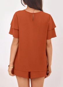 Detail of back water drop button closure and layered ruffle sleeves on summer set