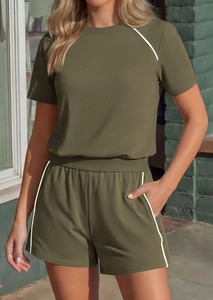 Detail of olive green lounge set showing white piping on sleeves and drawstring shorts