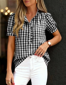 Detail of ruffled neckline and button-front on black and white gingham short sleeve shirt