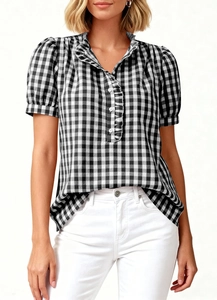 Detailed close-up of V-neck gingham plaid shirt featuring delicate ruffle trim and soft sleeves