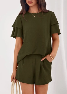Detail of elegant dark green two-piece set featuring layered ruffle sleeves and texture