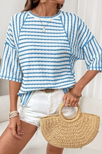 Detail of blue and white striped t-shirt with textured fabric and classic crew neck design