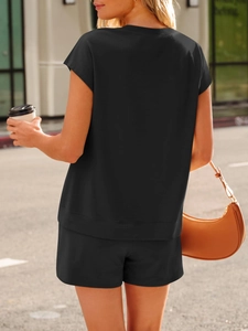 Back view of a casual black two-piece knit set featuring a relaxed top and matching shorts