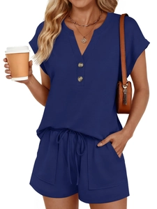 Detail view of dark blue V-neck short sleeve top and drawstring shorts with large side pockets