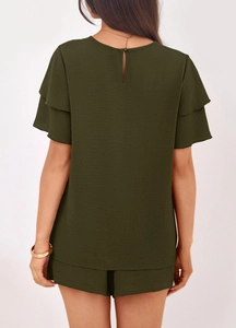 Detail view of dark green textured fabric with back keyhole button on two-piece summer set
