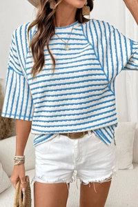 Close-up of blue and white striped knit t-shirt with textured fabric and crew neck