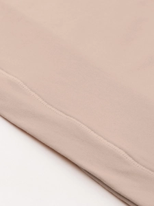 Détail du gros plan sur la couture plate à double aiguille du tissu beige sculptant