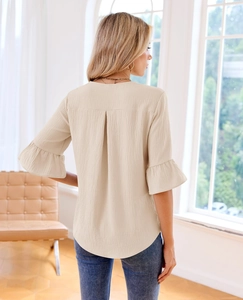 Detail of ruffle sleeves and textured crepe fabric on a beige 3/4 sleeve casual blouse