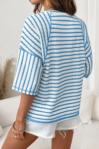 Detail of blue and white striped seersucker T-shirt fabric texture and relaxed fit style