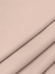 Gros plan sur un tricot côtelé de haute qualité beige clair avec détails texturés