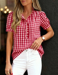 Detailed close-up of red and white gingham short sleeve shirt with ruffled button placket