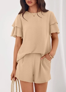 Detailed macro view of the ruffled short sleeves and textured fabric on summer set