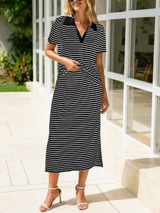 Outdoor shot of a chic black and white striped two-piece skirt set with a polo collar