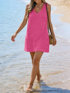 Detail of vibrant rose pink waffle knit V-neck sleeveless beach dress with side pockets