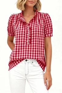 Detail of red and white checkered short sleeve shirt featuring a ruffled stand collar