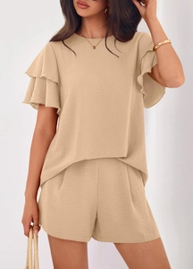 Detail of elegant ruffled double-layered sleeves on summer textured beige two-piece set