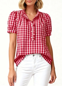 Detail of red gingham puff sleeves and ruffled button placket on a summer shirt