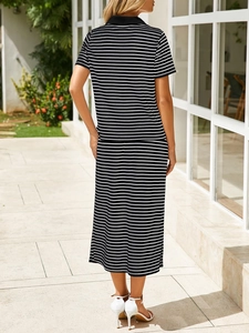 Detail of a black and white striped knit two-piece set featuring a polo top and midi skirt