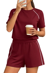 Detail of burgundy two-piece loungewear set with white piping trim and elastic waist