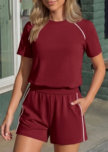 Close-up of wine red sports set with white stripe detailing and practical side pockets