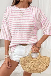 Detail of pink and white striped seersucker top with textured fabric and round neckline