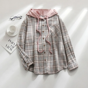 Detail of plaid hooded shirt with wooden buttons, pink drawstring and a cozy aesthetic