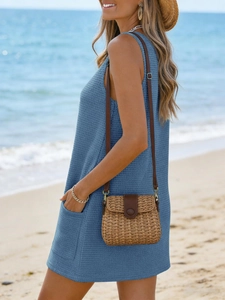 Close-up detail of blue waffle knit sleeveless beach dress with side pocket in sunlit beach