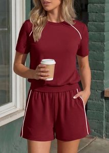 Detail of burgundy lounge set featuring white contrast piping and soft knit fabric
