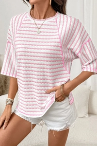 Detail view of pink striped crew neck T-shirt with textured seersucker fabric and side slits