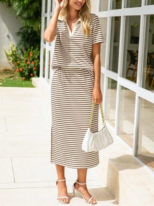 Detail of knitted polo top and striped midi skirt set showing ribbed texture and slit