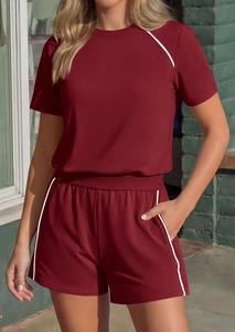 Detail view of burgundy loungewear set with white contrast piping and side pockets