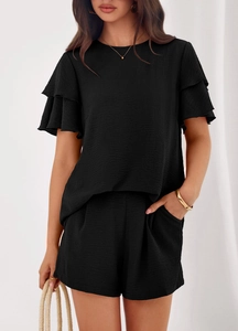 Detail of ruffle short sleeves and crinkle texture on a black two-piece casual set
