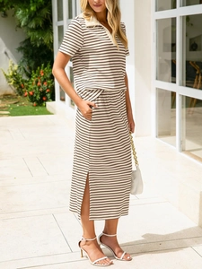 Detail of striped polo top and side slit midi skirt set in outdoor natural light setting