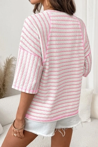 Detail of pink and white striped textured fabric showing back view and seam finish