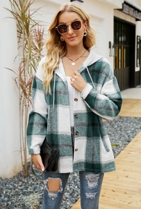 Detail of green plaid hooded shacket featuring button closure and soft brushed fabric
