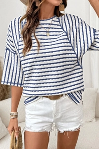 Detail of blue and white striped seersucker fabric texture on women's crewneck t-shirt