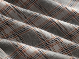 Detail shot of heavy grey plaid fabric with orange and blue stripes for winter hoodie jacket