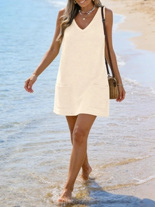 Detail of beige waffle knit V-neck sleeveless mini dress with two front square pockets