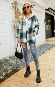 Close-up of green and white plaid hooded shacket styled with denim and boots